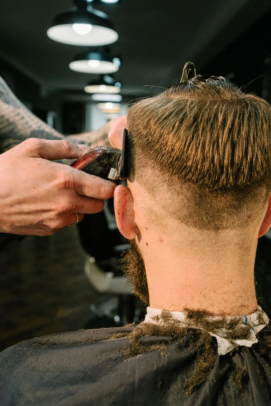 Barber giving a client a styled haircut, used in example ad two