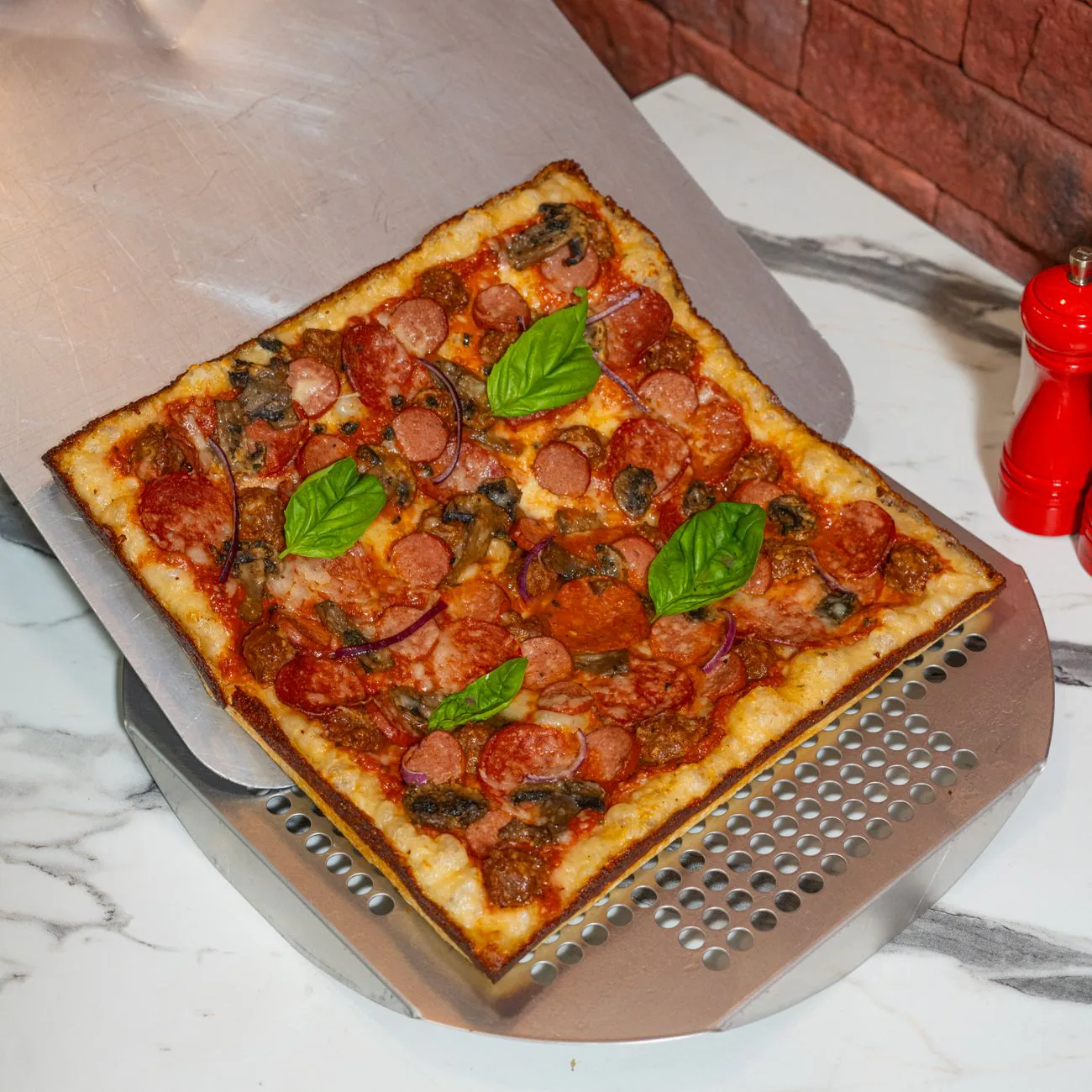 Motor City Pepperoni pie on a pizza peel