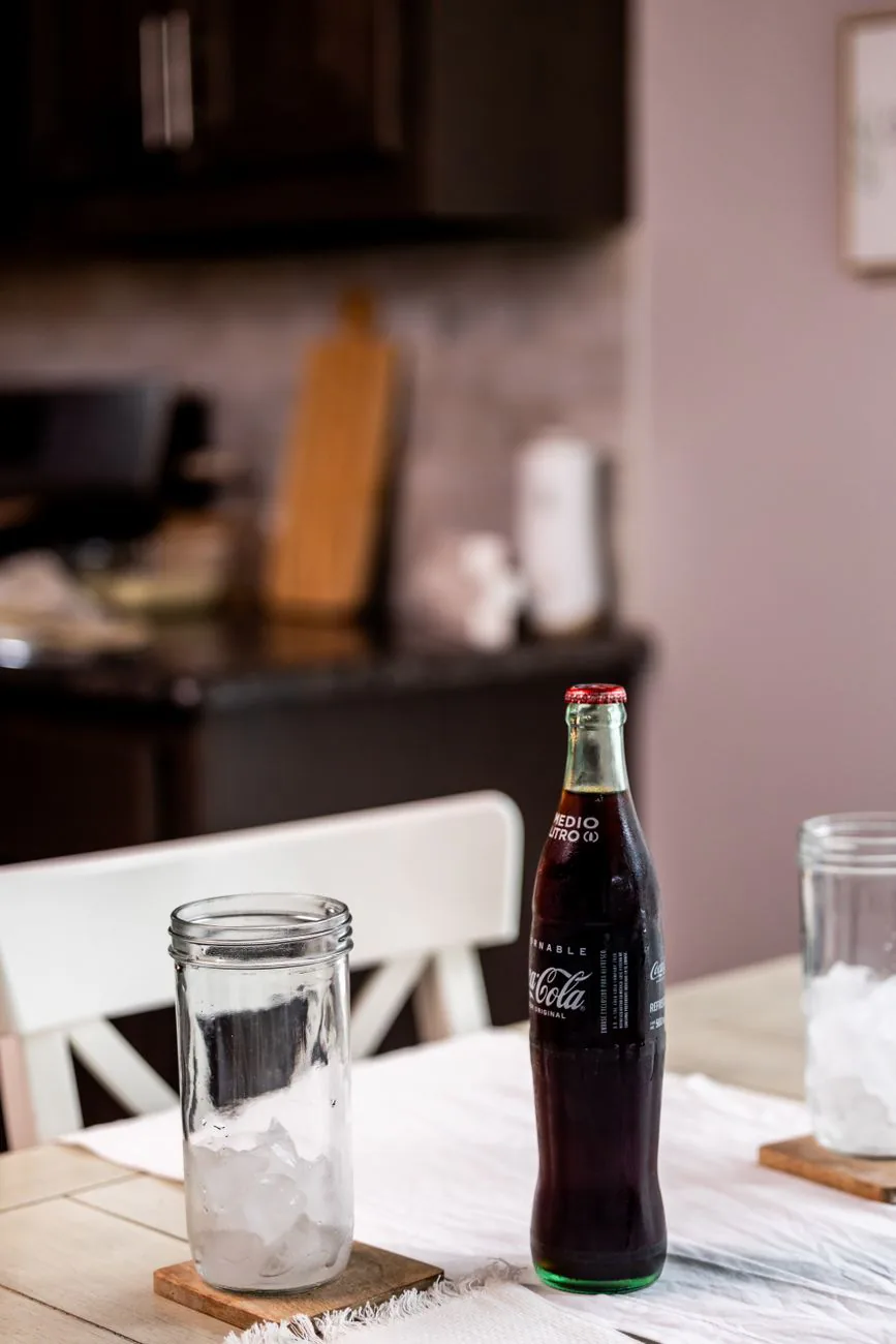 Glass bottle of soda on a table
