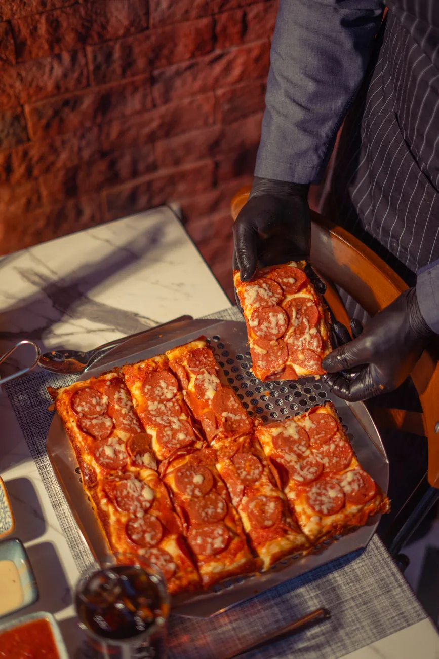 Motor City Meat Feast square pizza on a metal tray