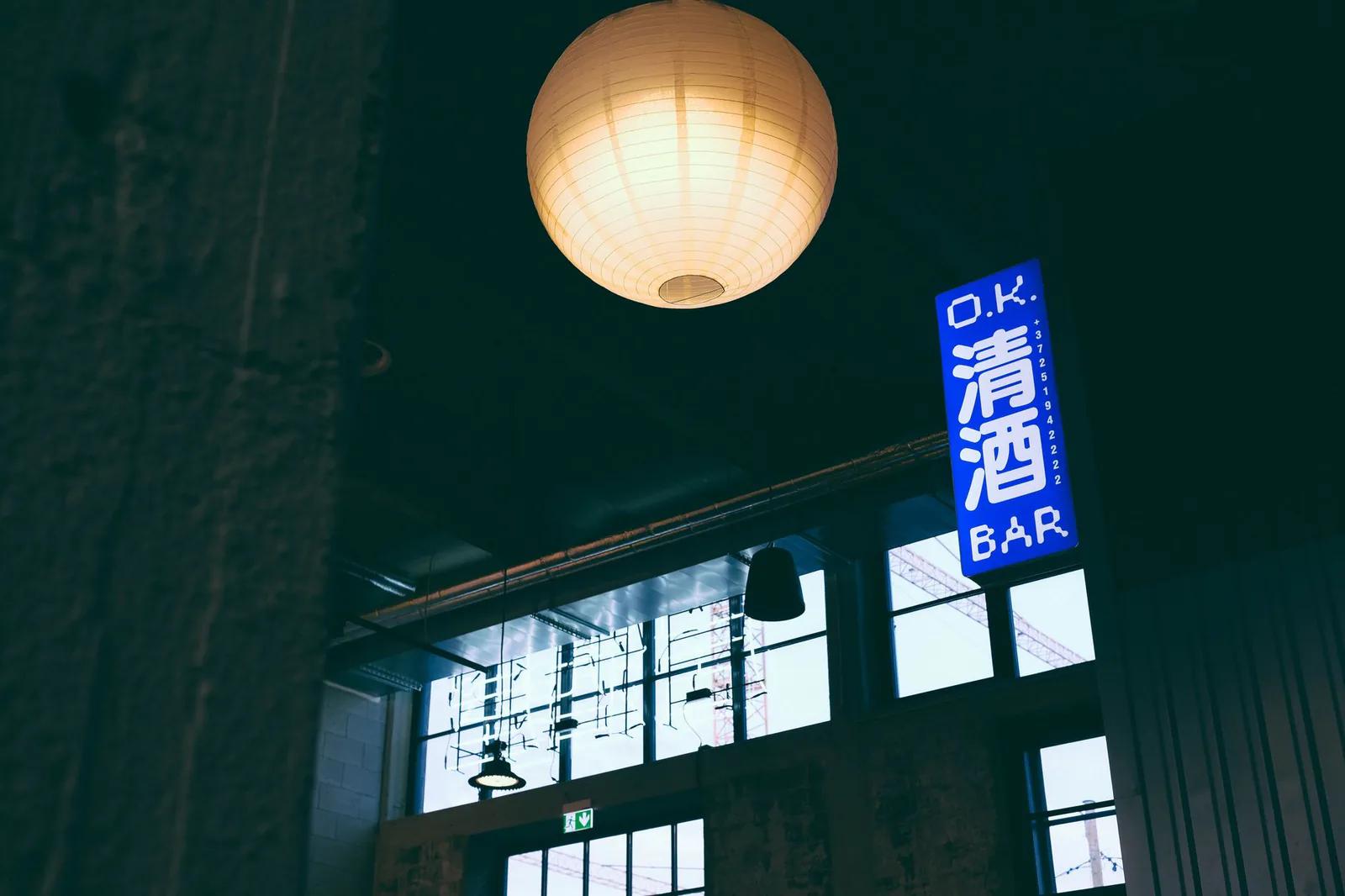 Warm neon-lit Japanese restaurant bar with paper lanterns