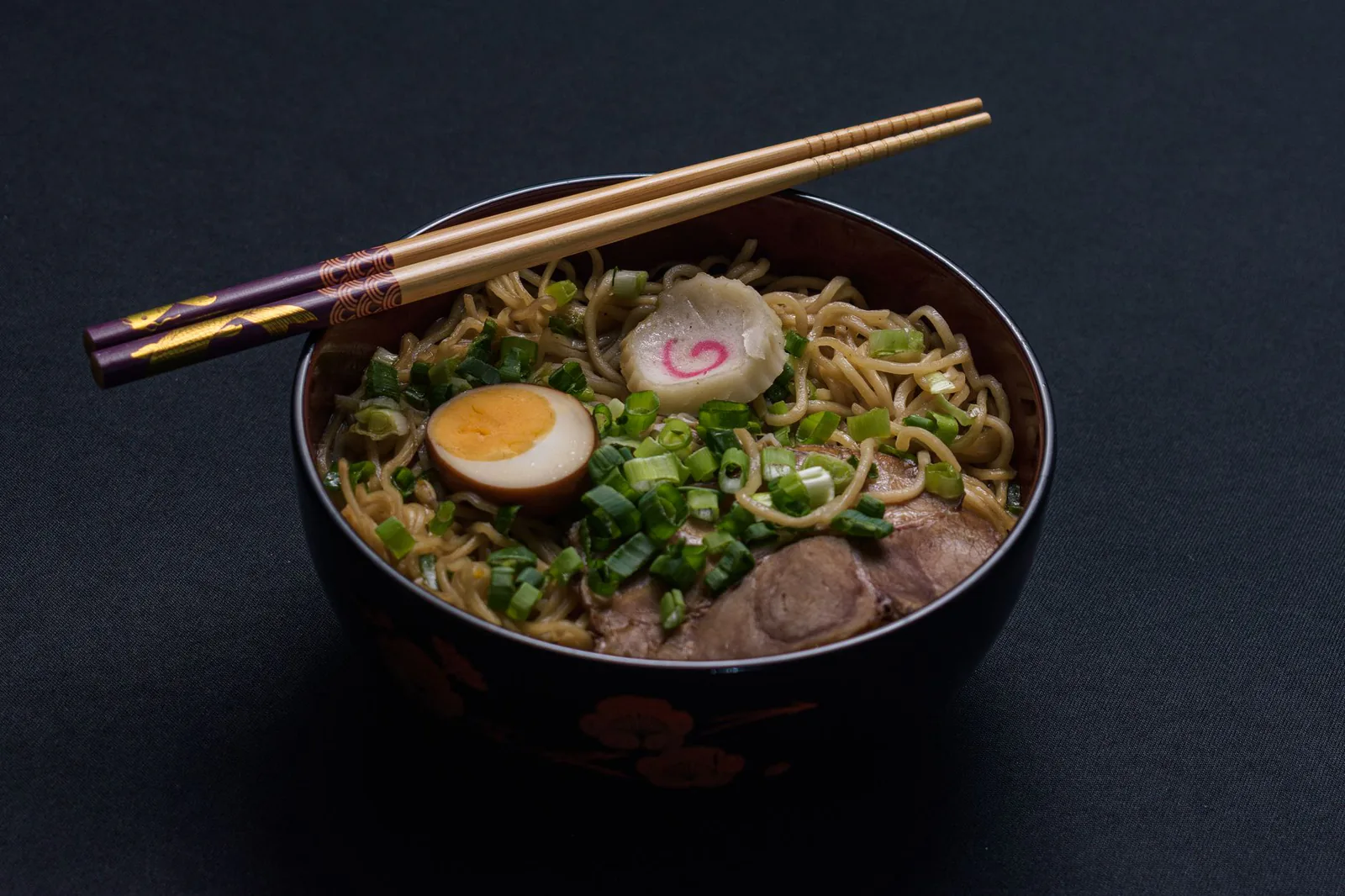 Bowl of Japanese ramen with egg and scallions