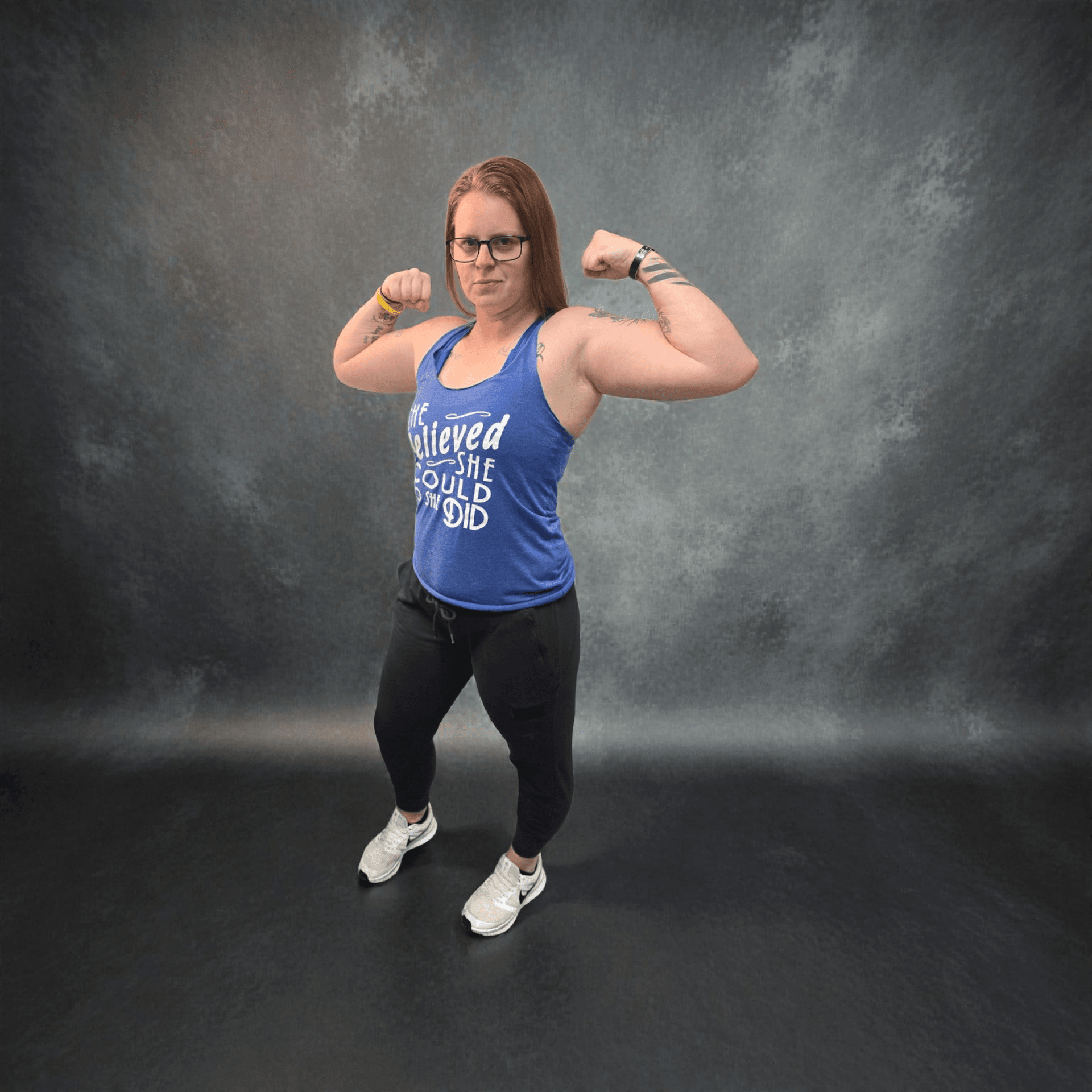 Andrea, fitness coach, flexing in a confident portrait pose