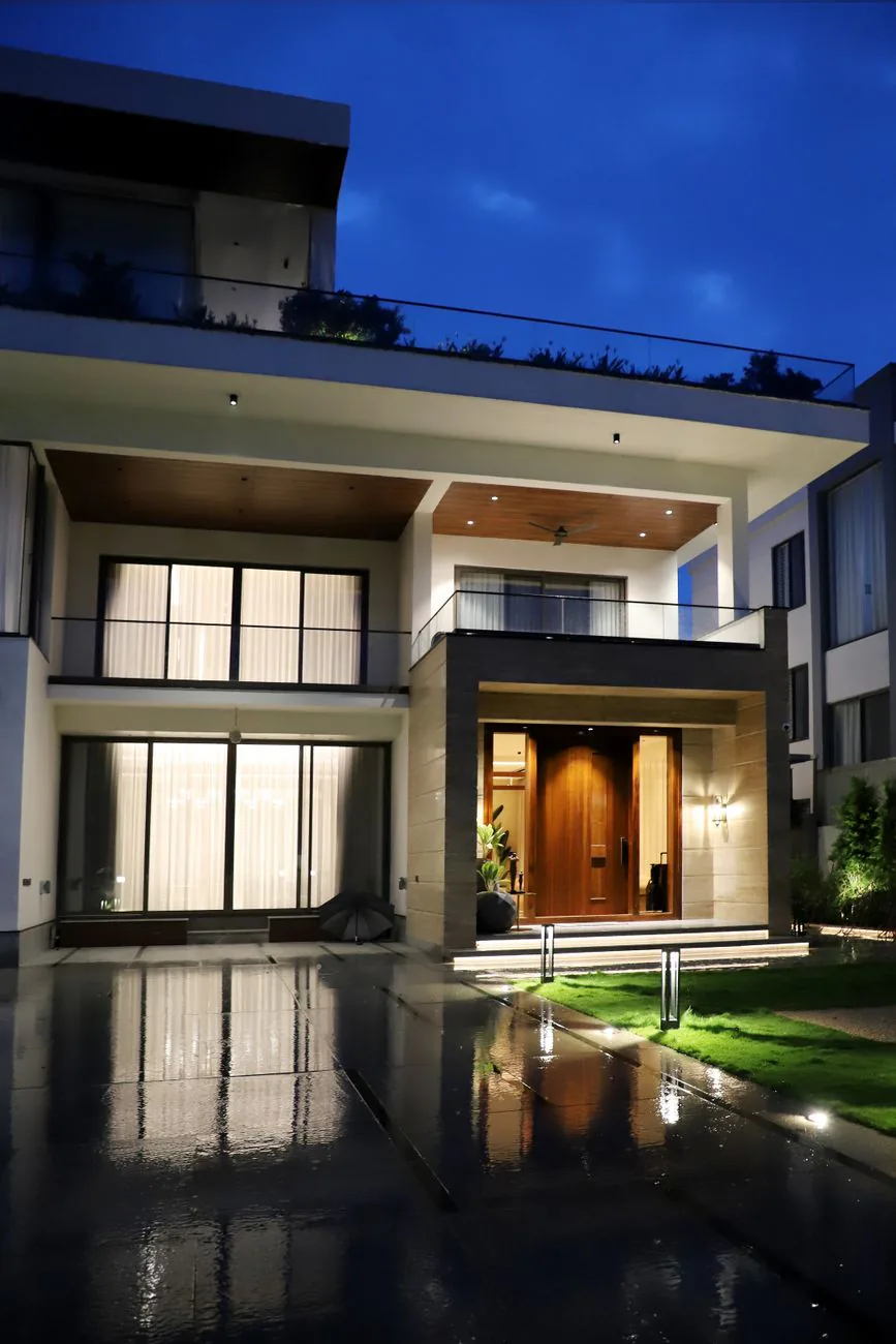 Modern luxury home exterior illuminated at night