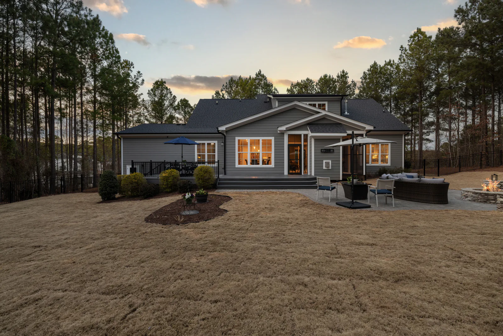 Custom home exterior glowing warmly at dusk