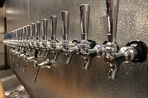 Beer taps lined up on the wall