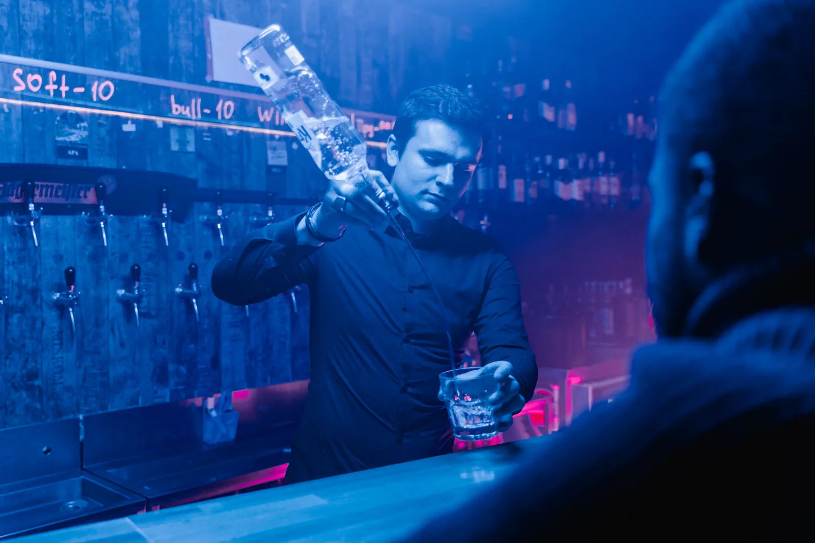 Bartender mixing drinks behind the bar