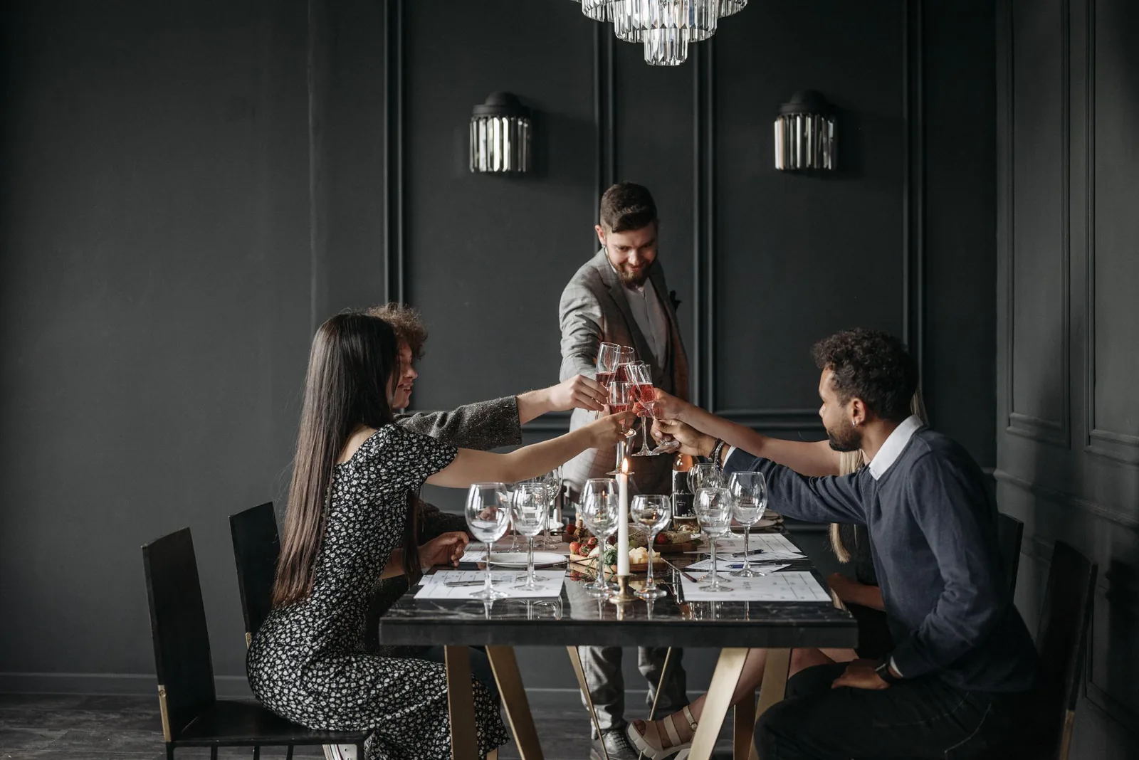 Friends raising glasses around a celebration table