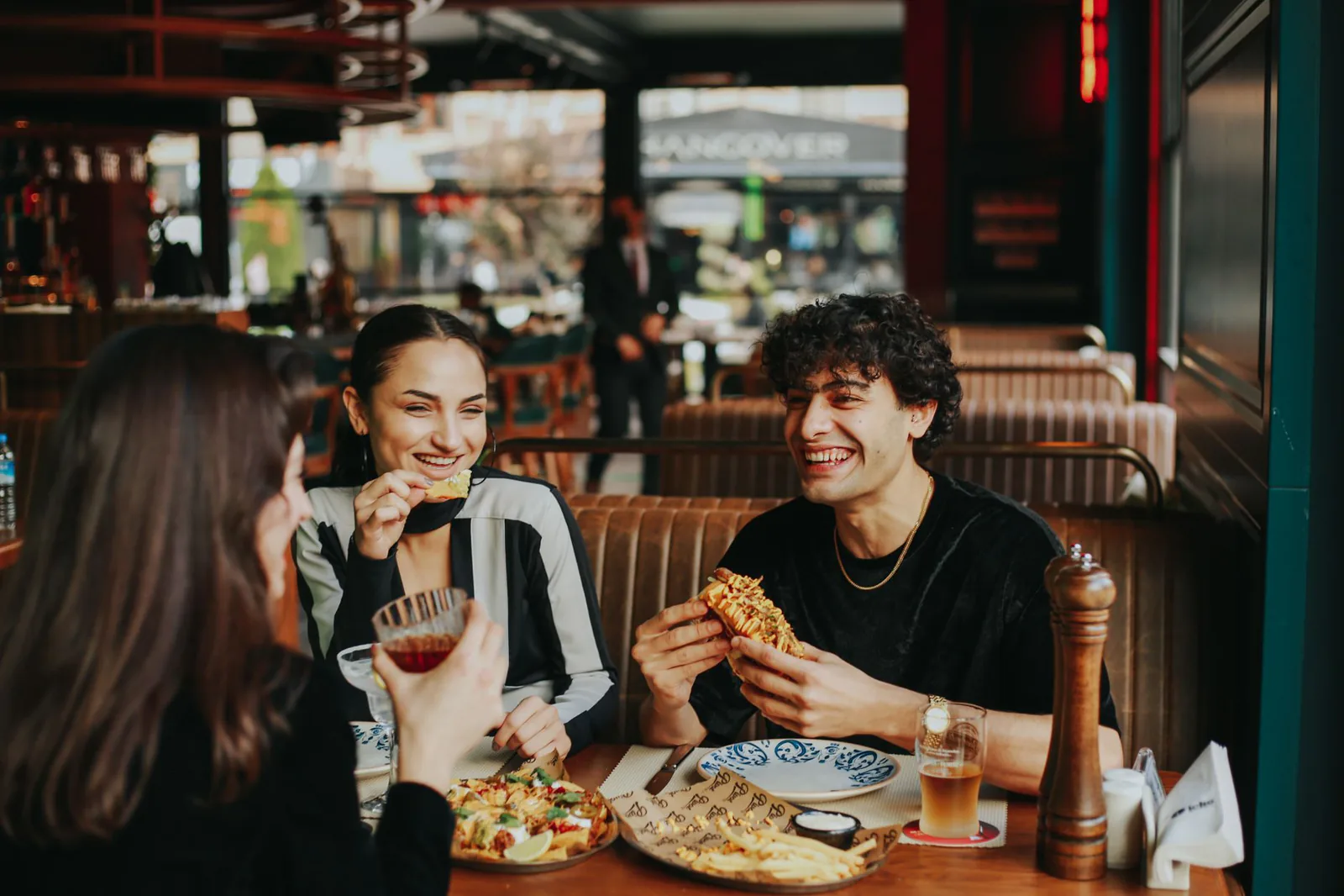 Friends laughing over brunch at Ellen's