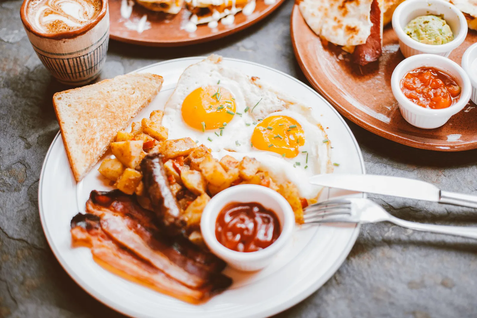 A hearty breakfast plate of eggs, bacon and toast