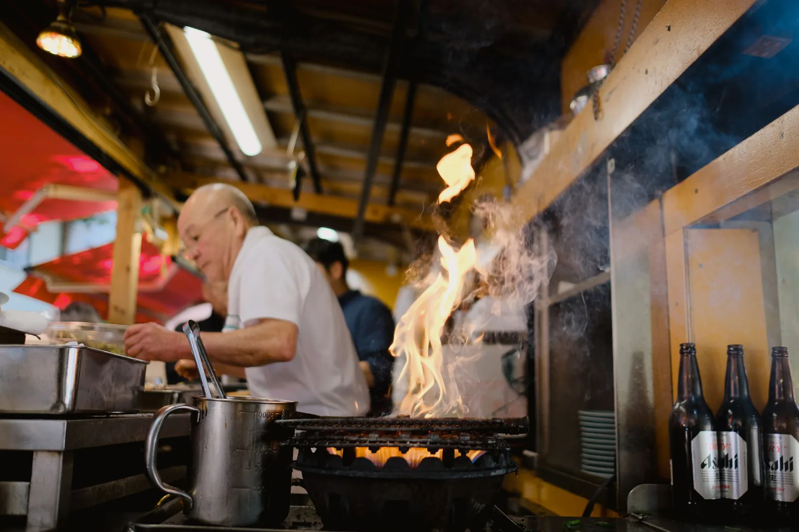 Ellen's kitchen team cooking over open flame