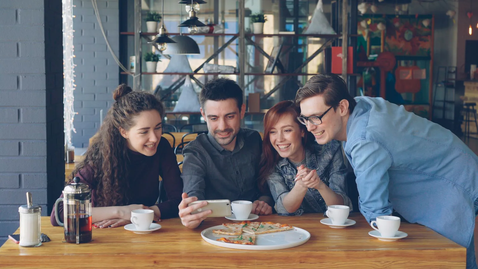 Friends sharing coffee and laughs at the table