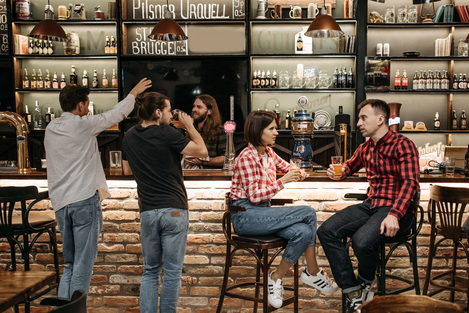Friends laughing together over drinks at the Eno's bar
