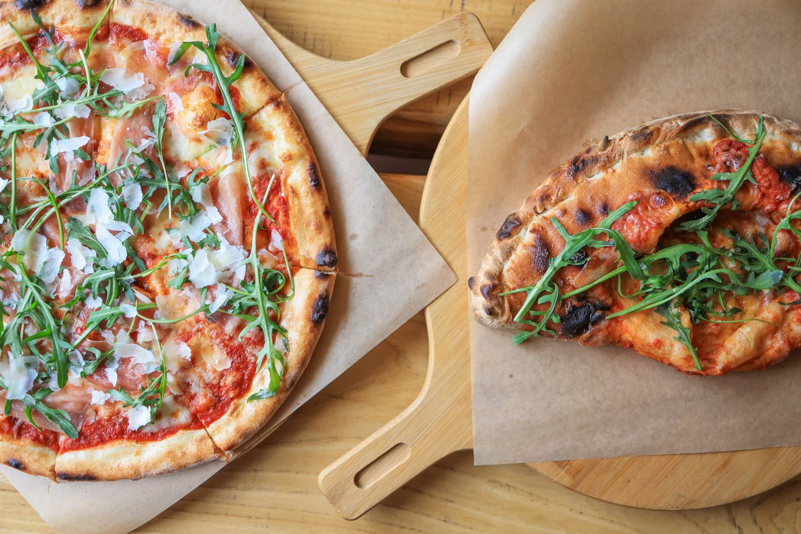 Fresh wood-fired pizzas served on wooden boards