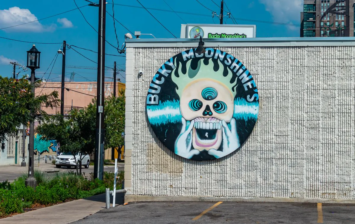A vintage restaurant sign glowing on a Dallas street
