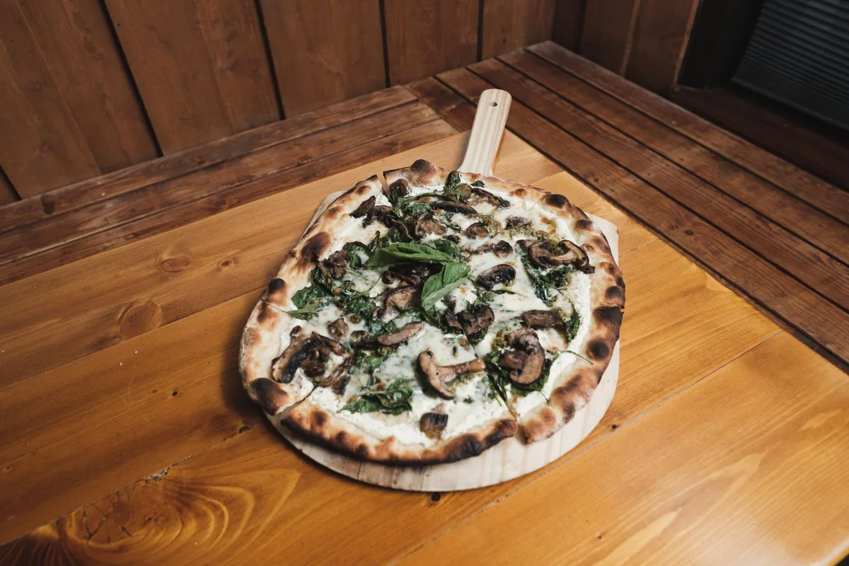 Mushroom and spinach pizza fresh from the oven