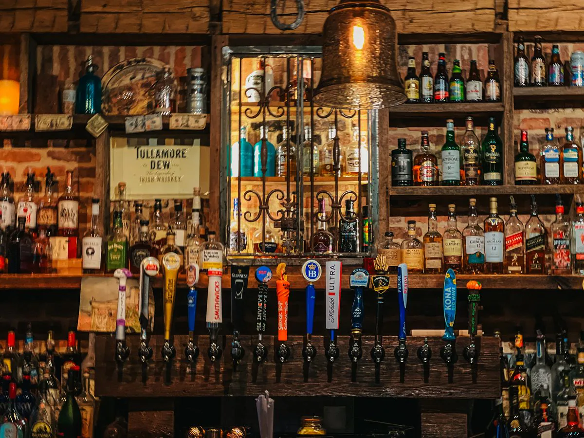The Eno's bar lined with bottles under warm light
