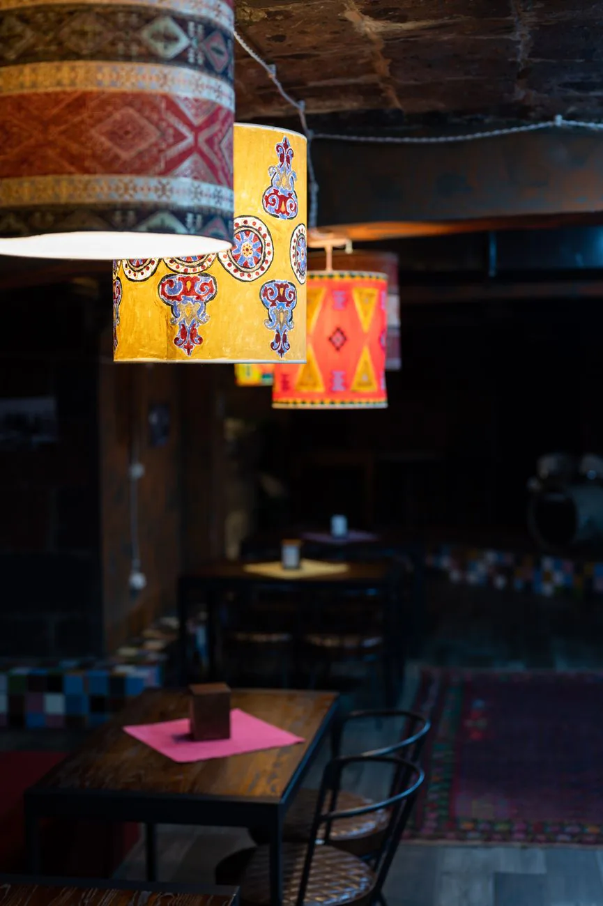 Colorful lampshades glowing over the dining room