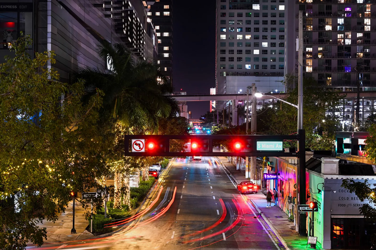 Illuminated Miami avenue at night with light trails