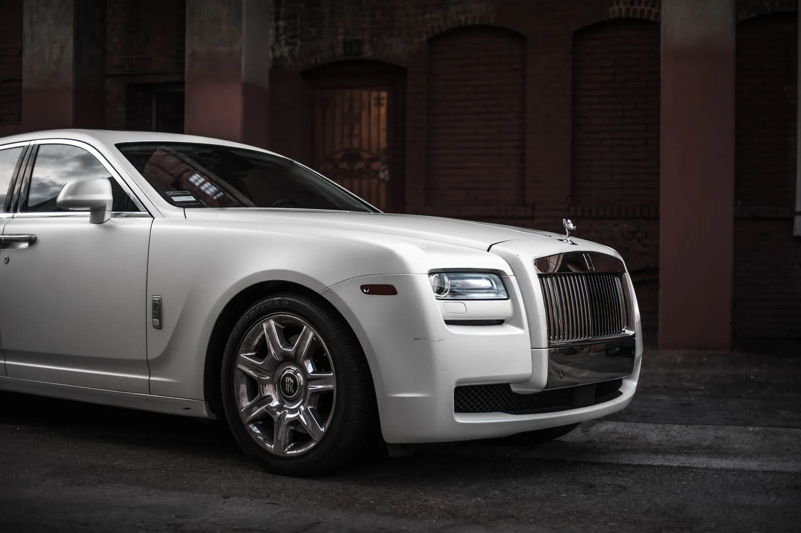 White luxury sedan parked on an elegant city street