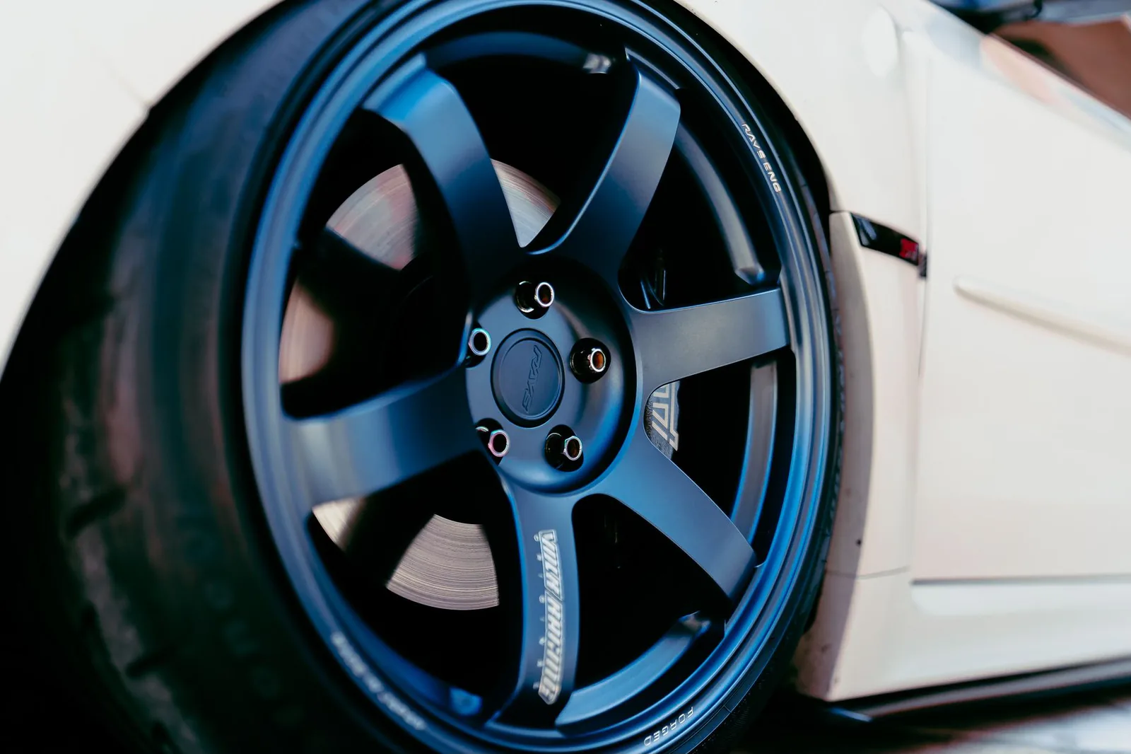 Black alloy wheel and tire on a sleek vehicle