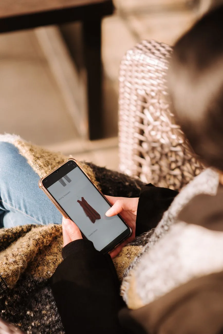 Elizabeth Mulkey app — woman browsing a membership app on her phone