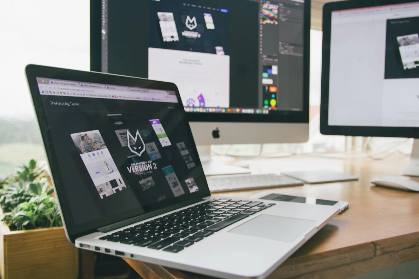 Studio workstation running design software across multiple screens