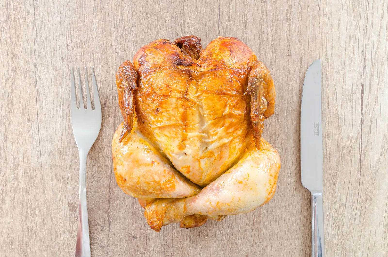 Whole roasted rotisserie chicken plated