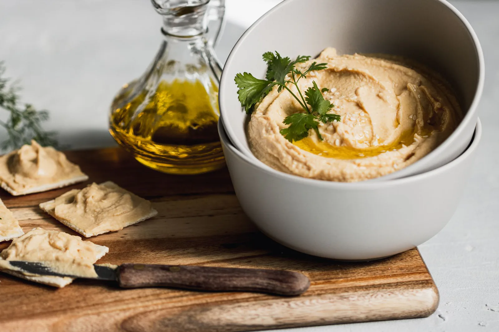Hummus bowls with olive oil and crackers