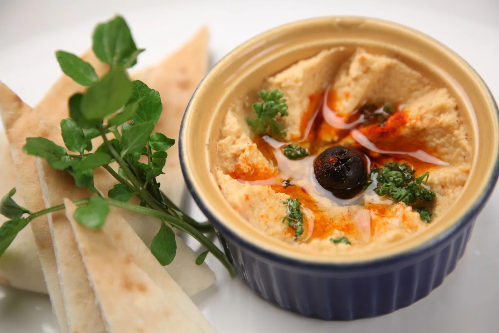 Bowl of creamy white bean hummus with pita