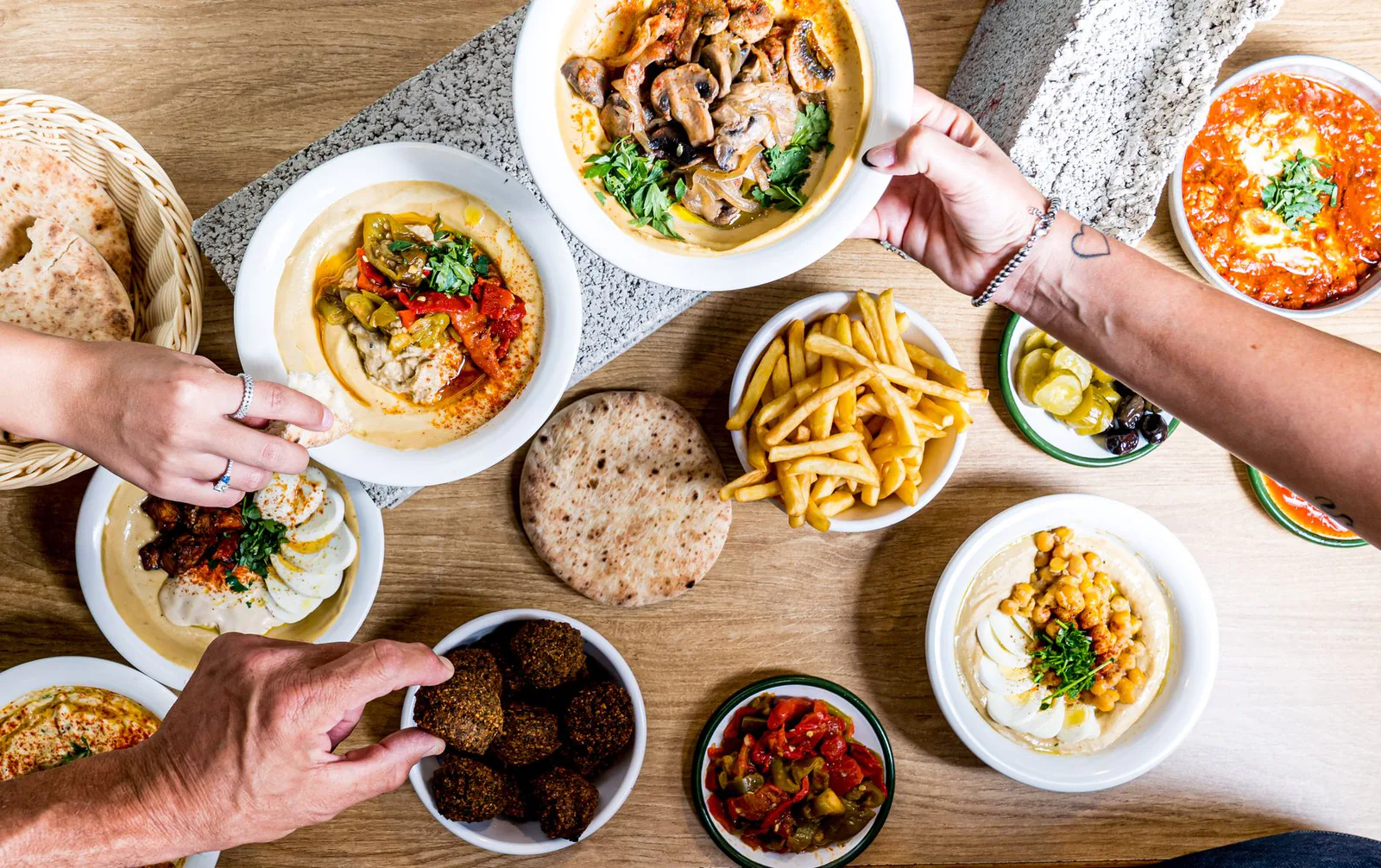 Table full of Mediterranean dishes and mezze spreads