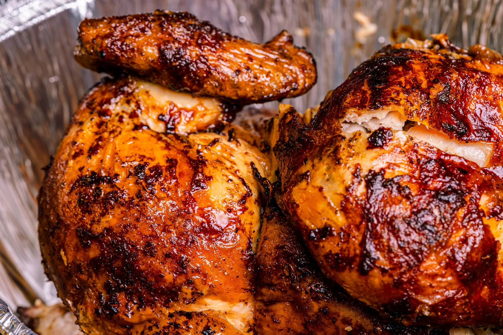 Golden rotisserie chicken with crispy skin, fresh off the spit