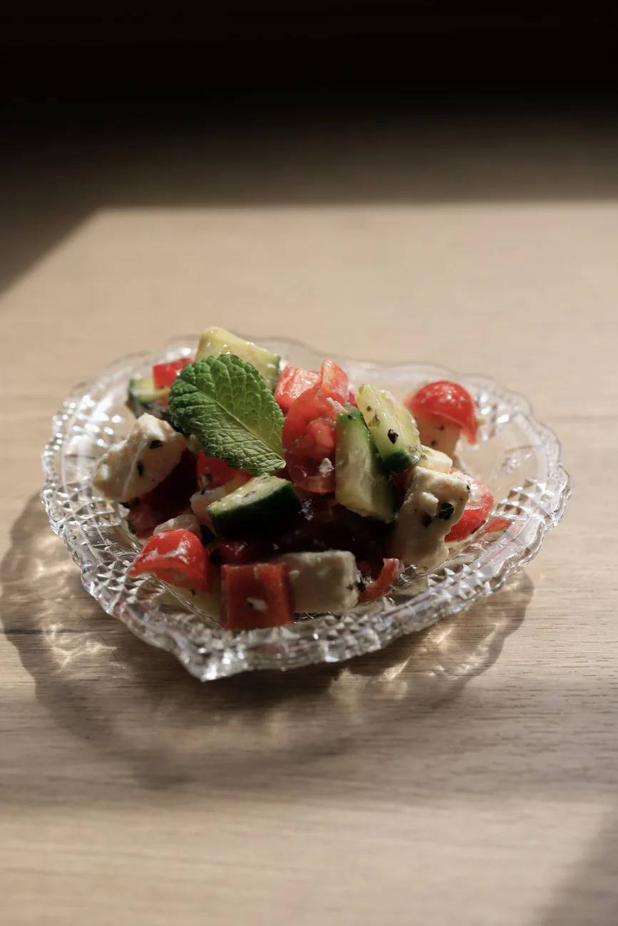 Fresh salad with feta in a glass bowl