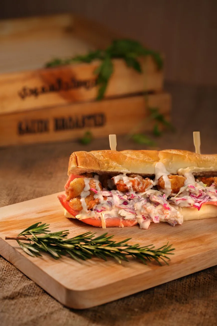 Stacked pulled chicken sandwich on a board