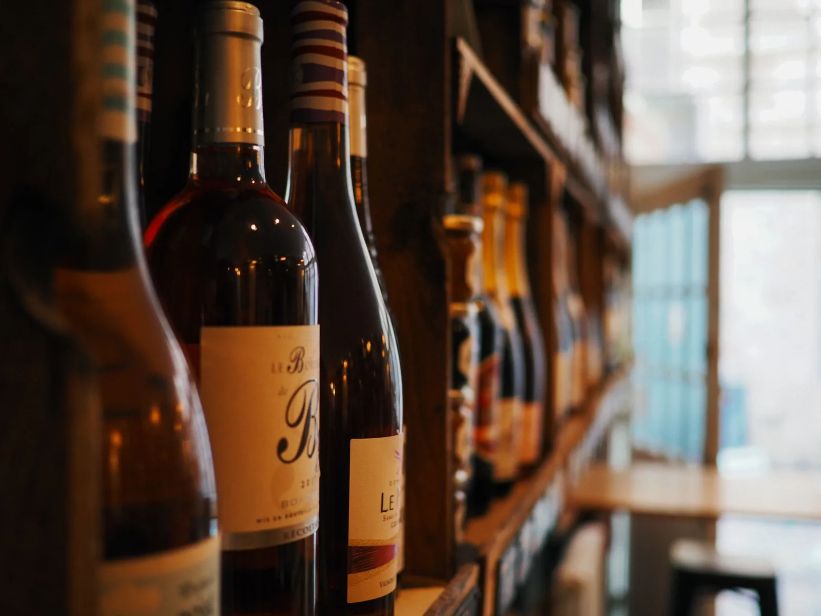 A cozy European-style wine selection on wooden shelves