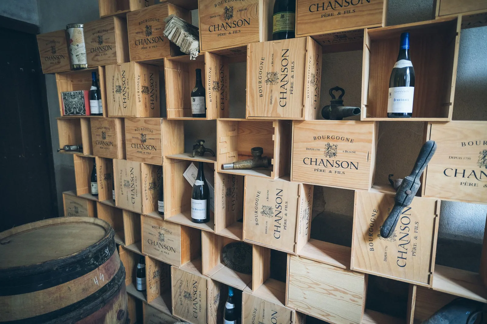 Rustic cellar shelves stacked with wooden wine crates