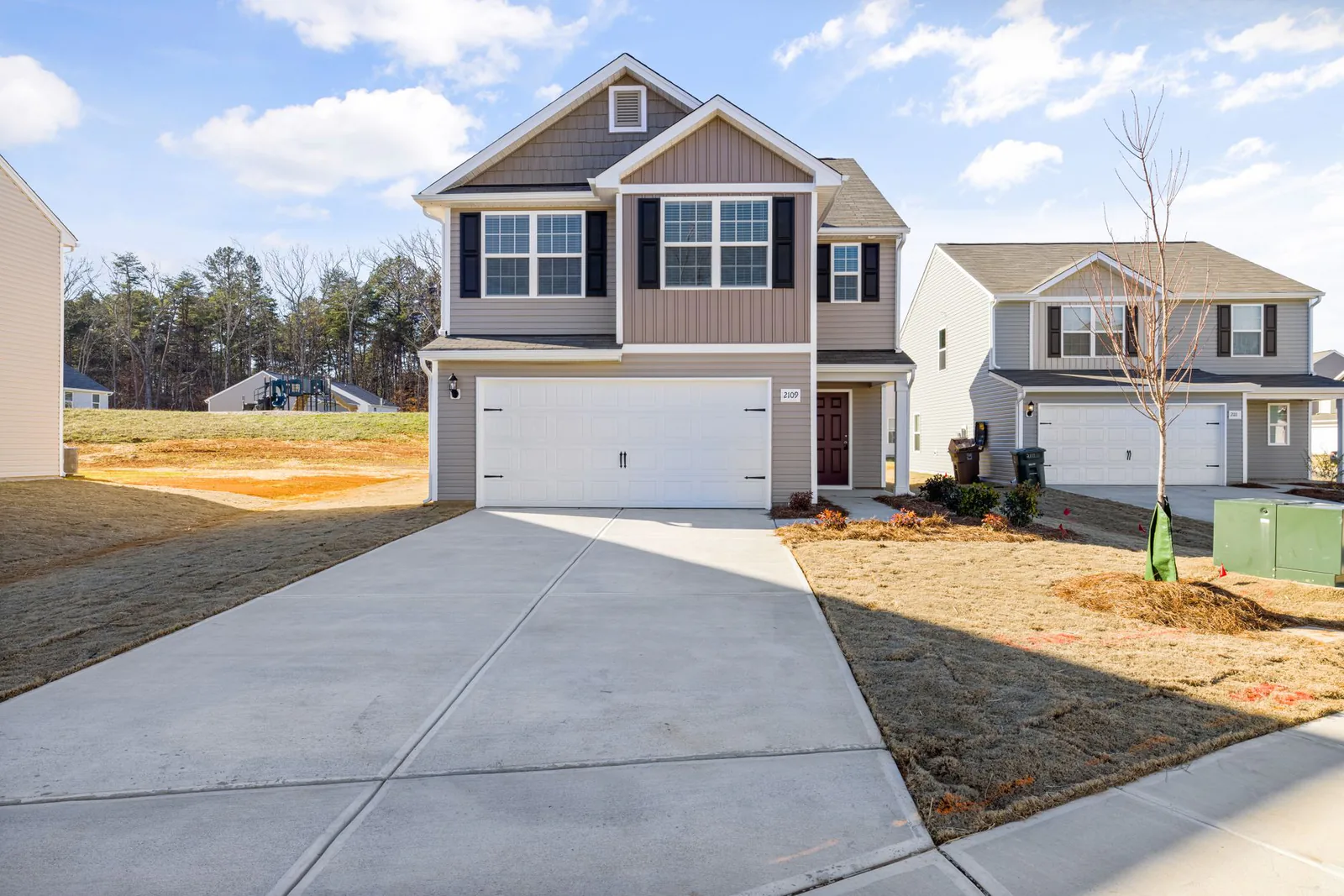 Wide concrete driveway extension adding parking space at a home