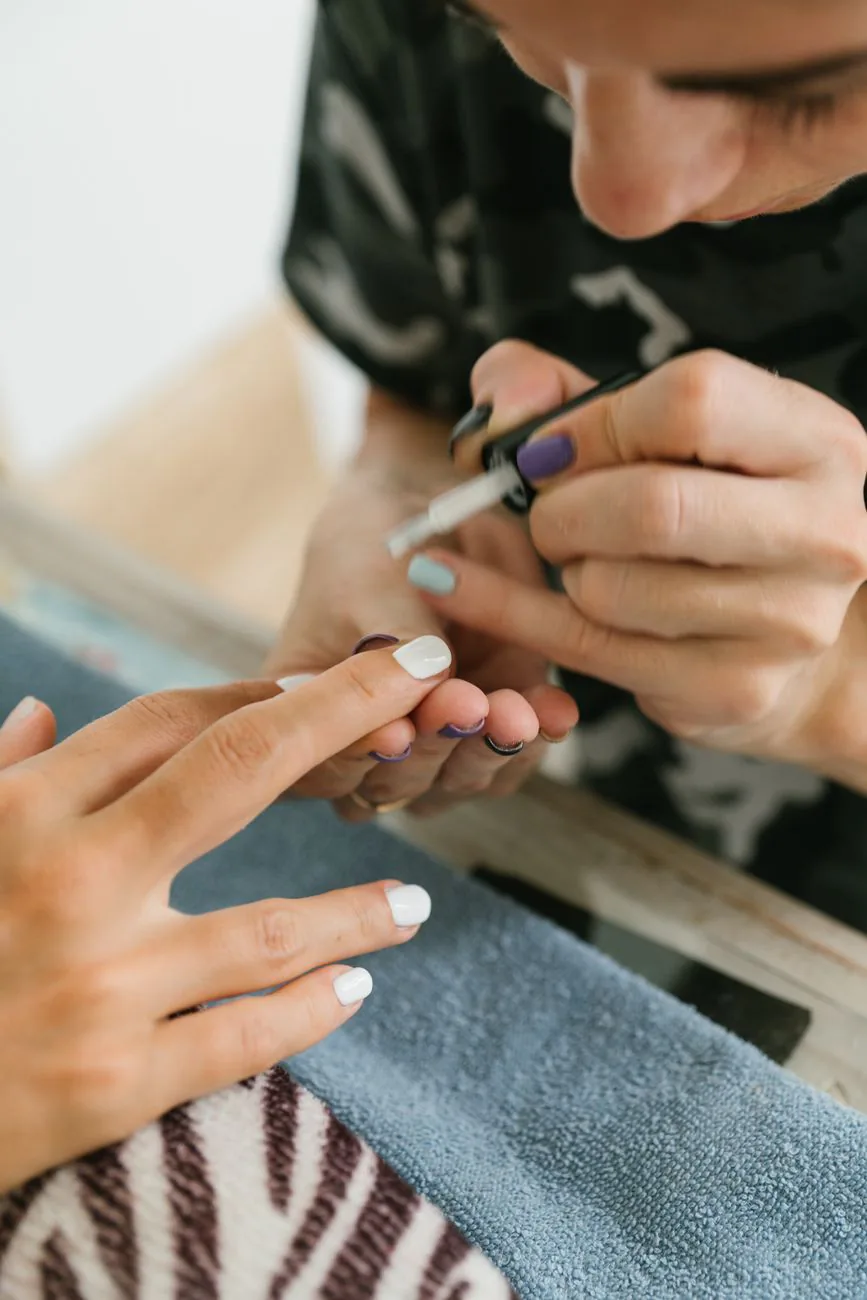 Manicurist painting nails with precision