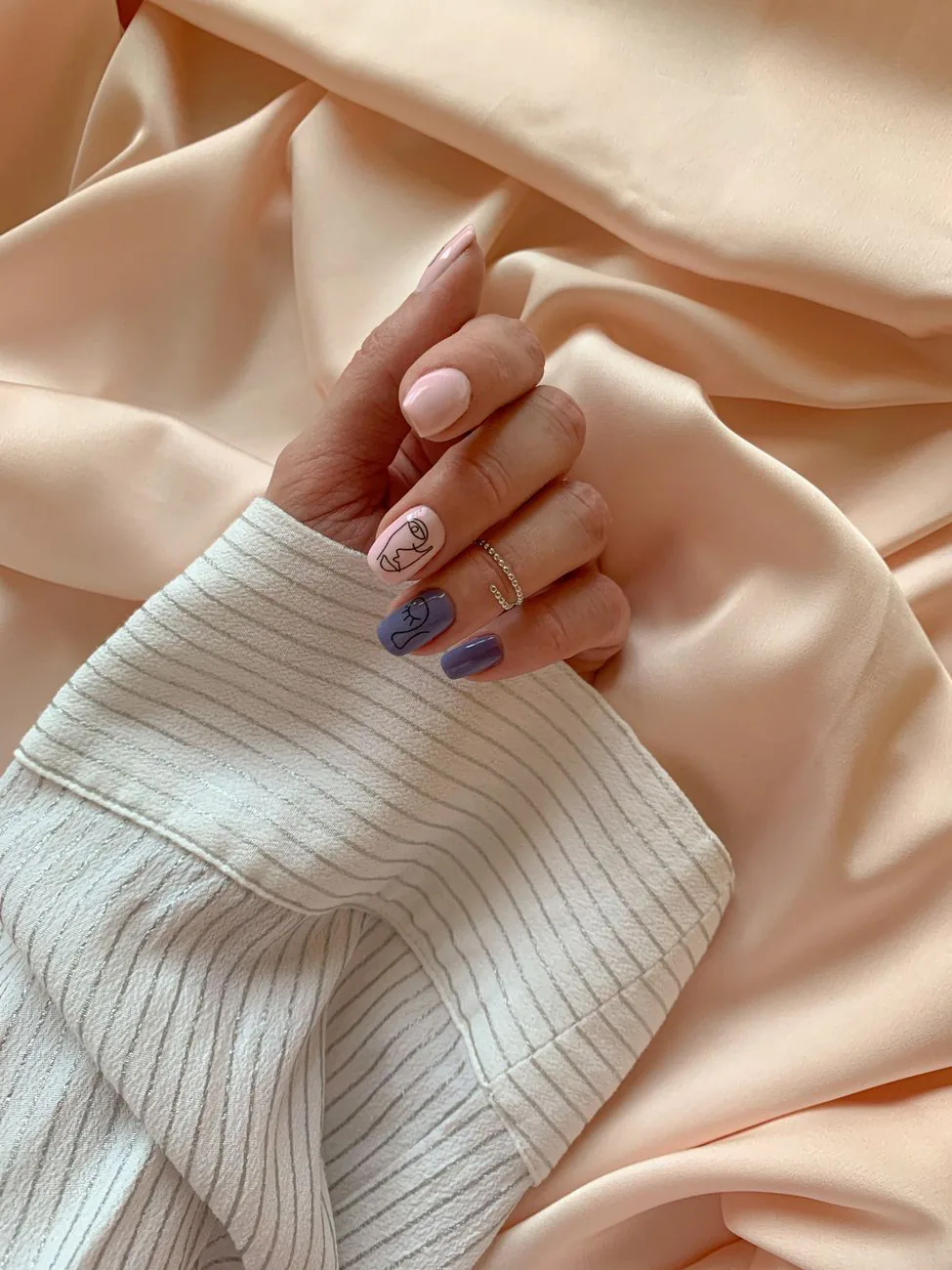 Pastel manicured nails on soft fabric
