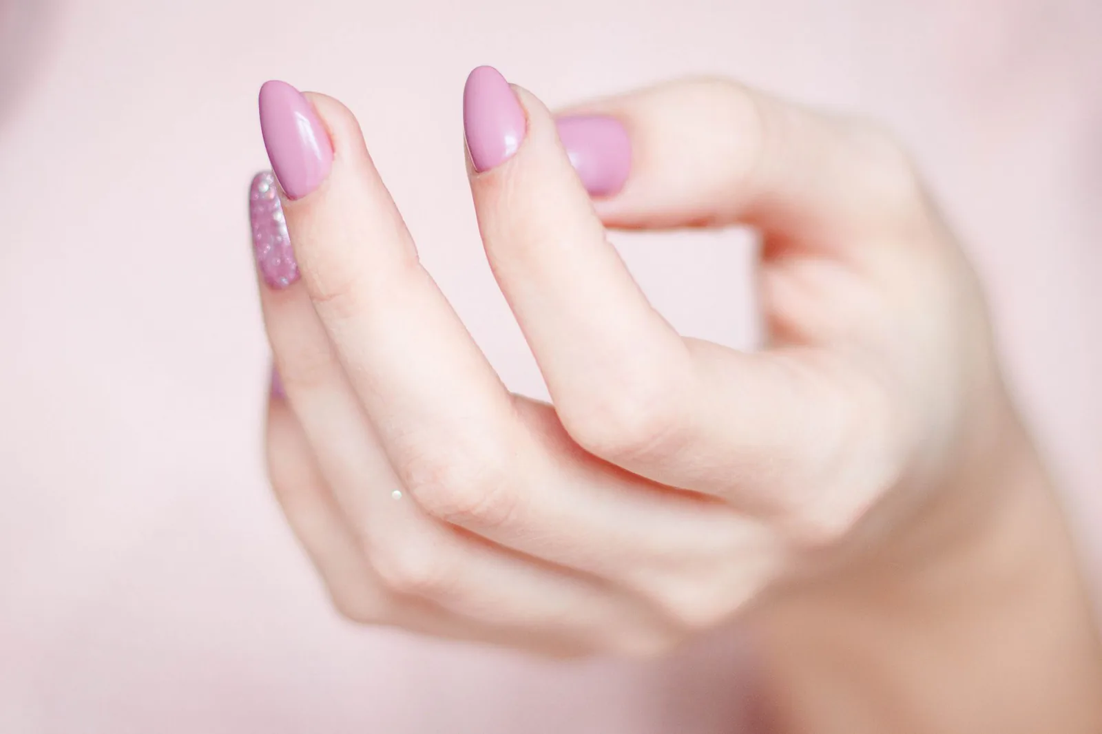 Soft pink manicure with delicate glitter detail
