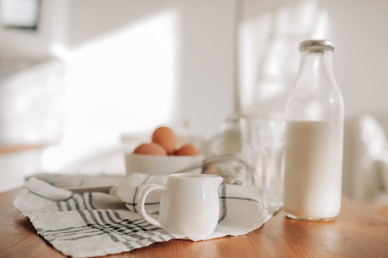 Milk bottle and farm eggs in a bright kitchen