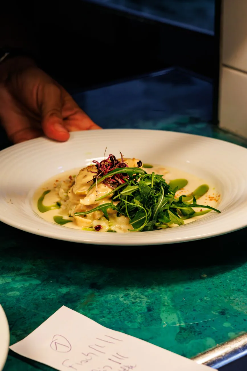Golden baked frittata slice on a plate with fresh herbs