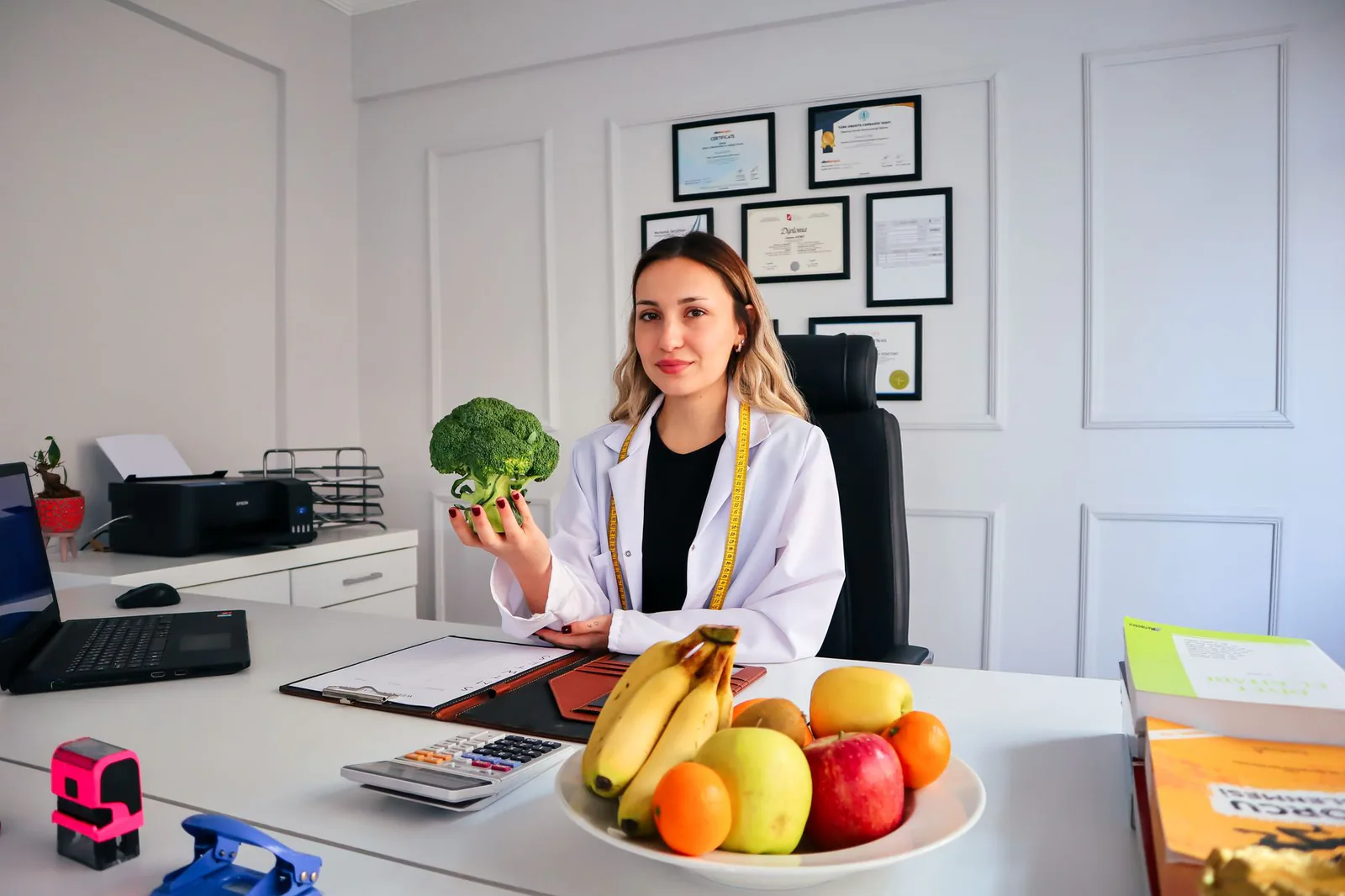 Nutritionist discussing fresh broccoli in the kitchen