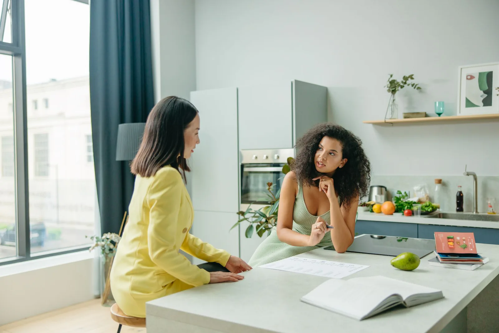 Two women talking about nutrition in a kitchen