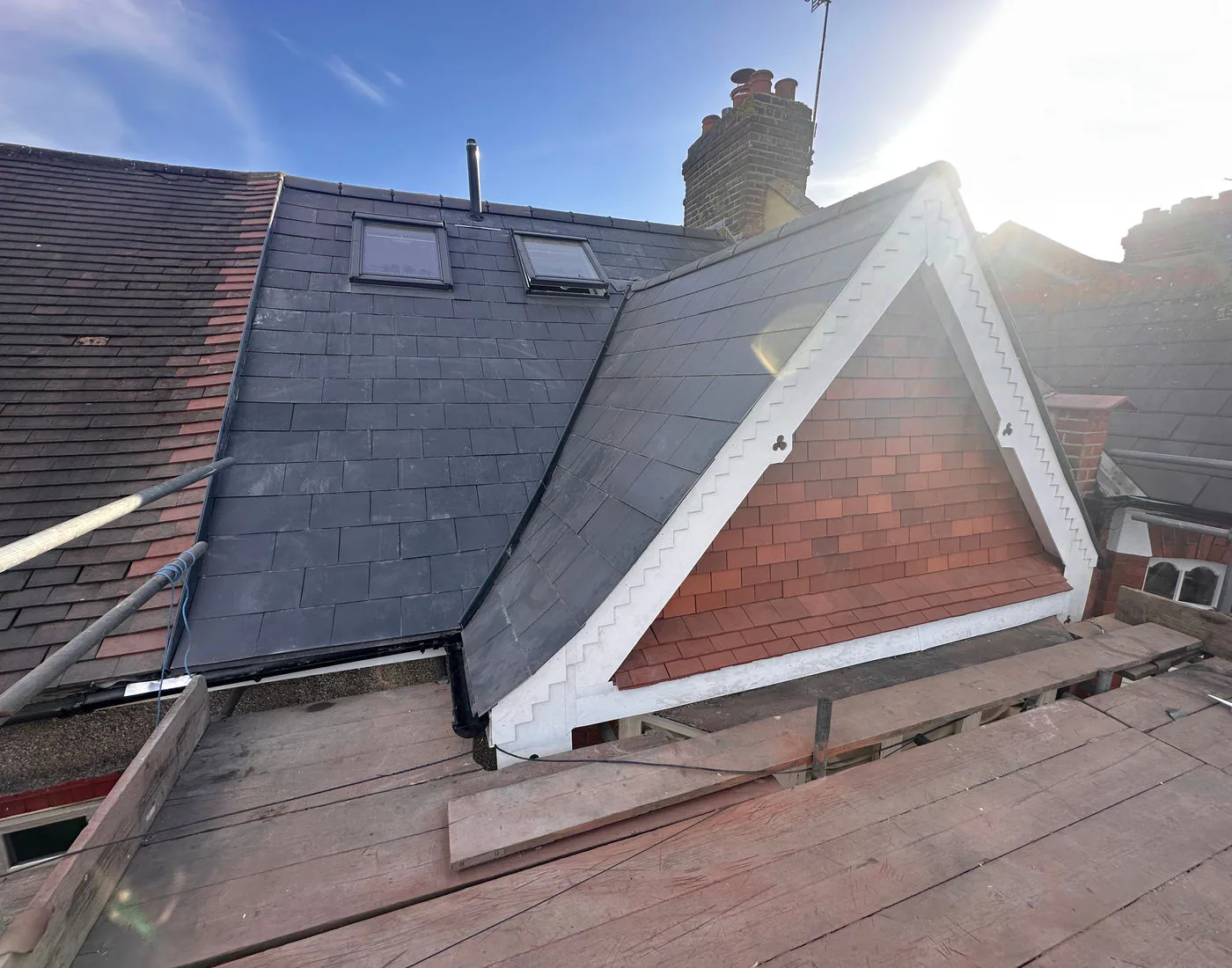 Roofer from OG Roofing Solutions working on a pitched roof