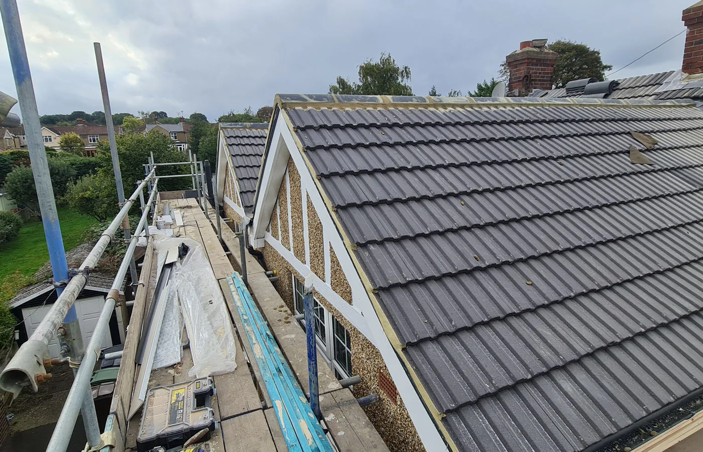 New pitched roof installation with fresh tiles and battens