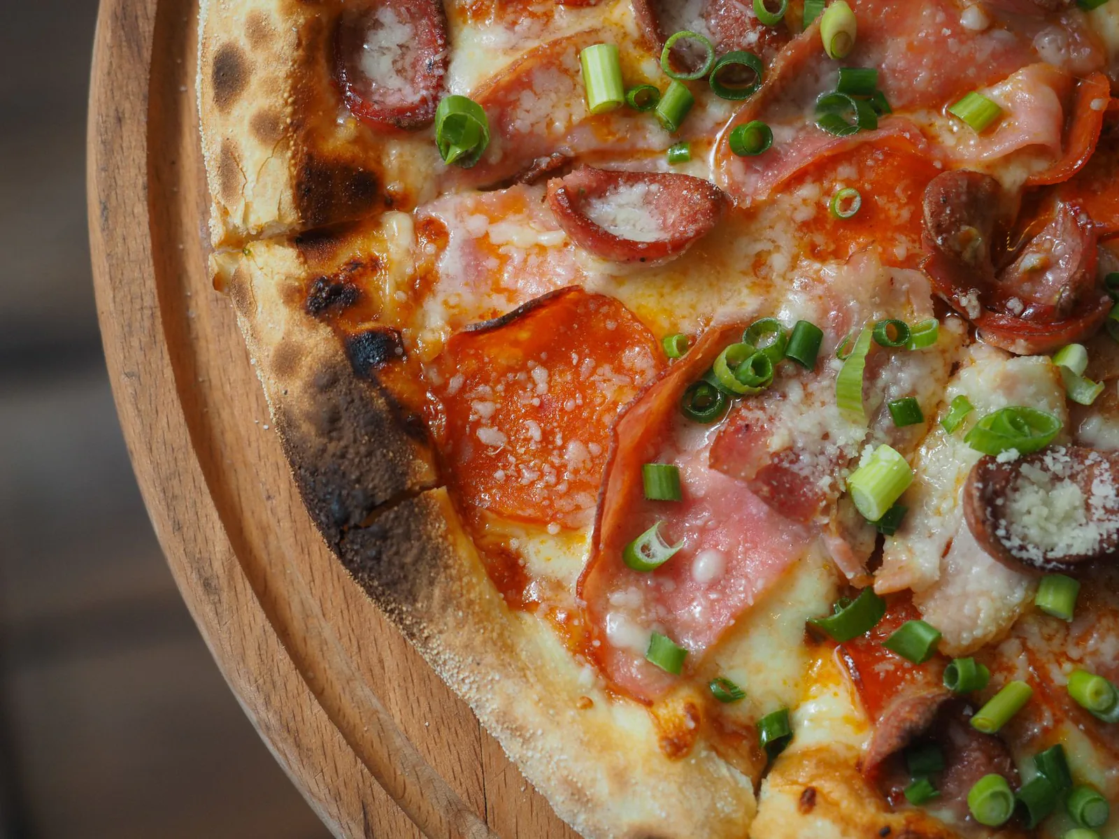 Pepperoni pie with melted cheese on a wooden board