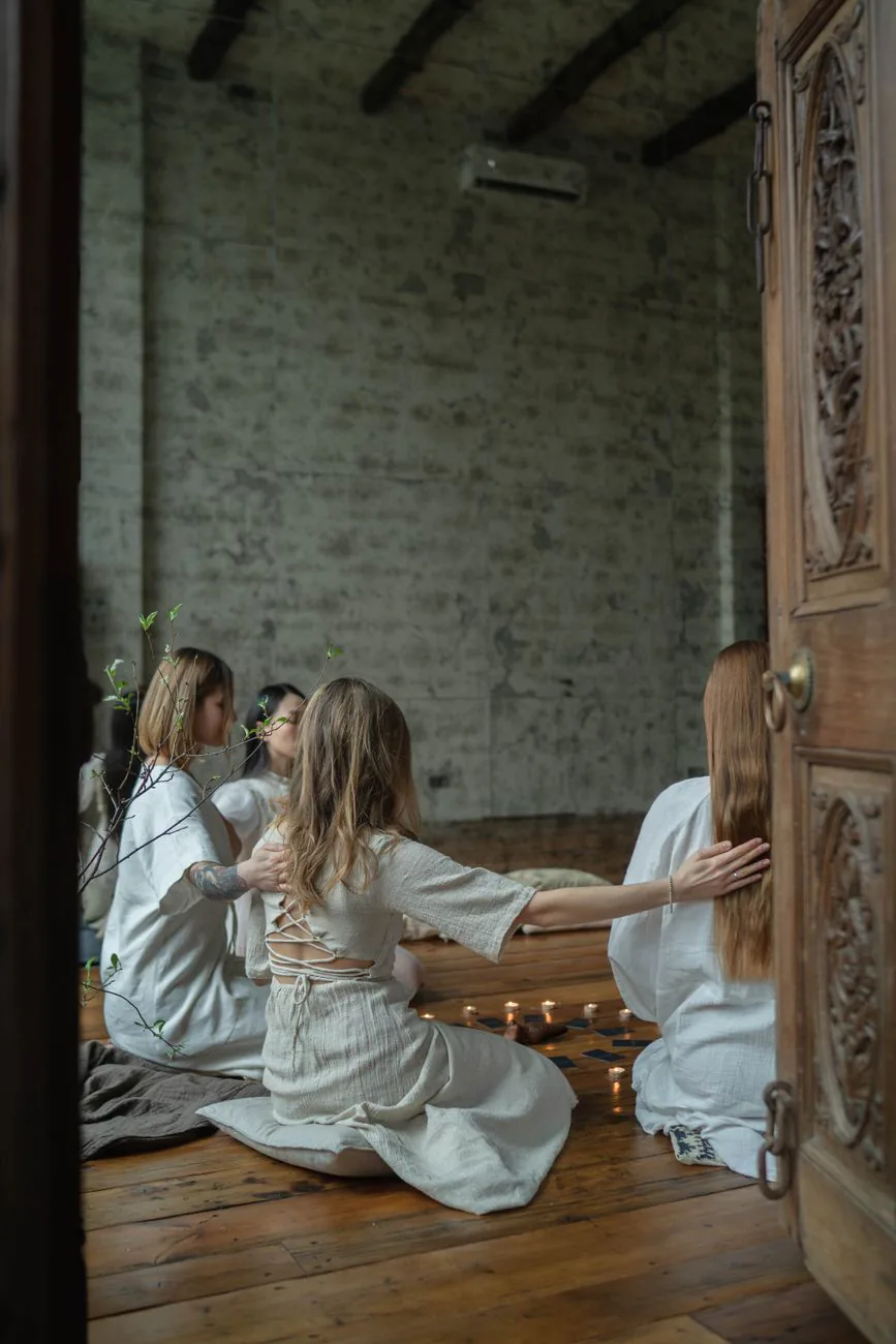 Women gathered in a quiet candlelit circle