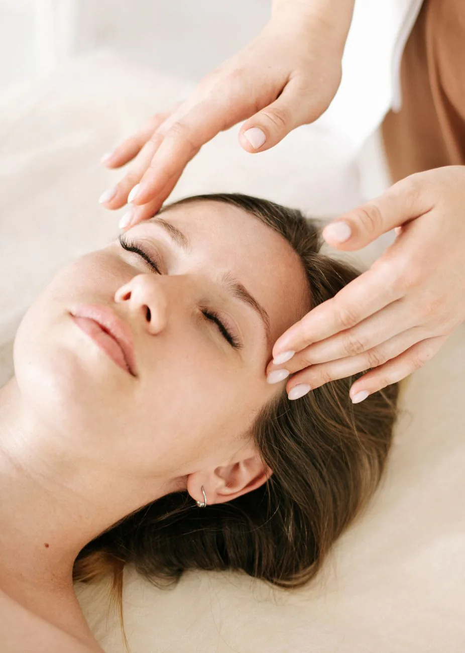 A woman receiving a slow facial treatment in warm light