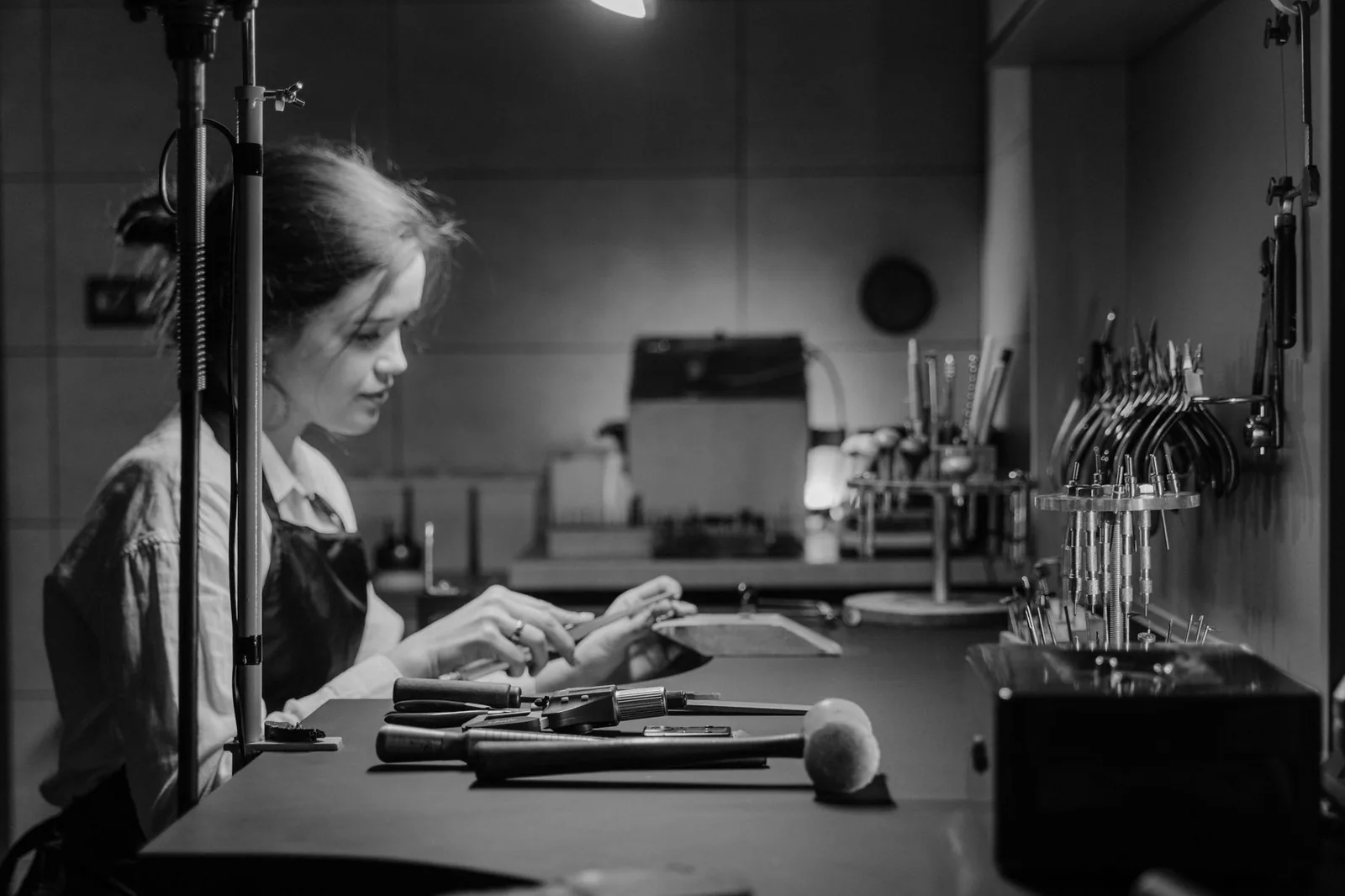 A jeweler at work at a well-equipped bench